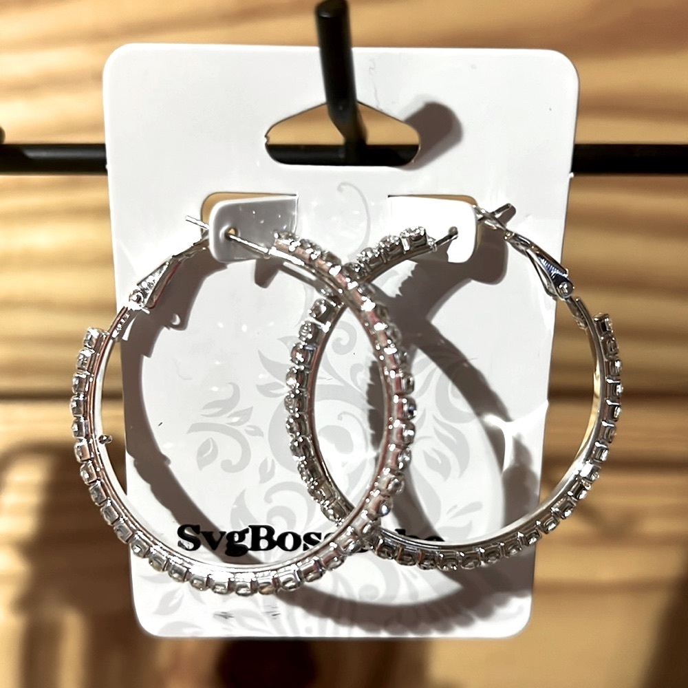 Rhinestone silver hoops that are littler. One pair available